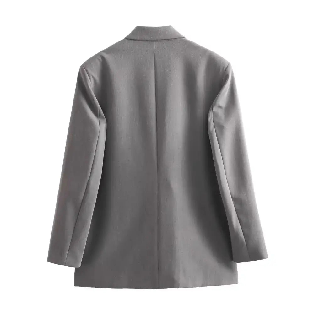 Vista traseira do blazer feminino de alfaiataria cinza, com corte reto e limpo nas costas, exibido em fundo branco.