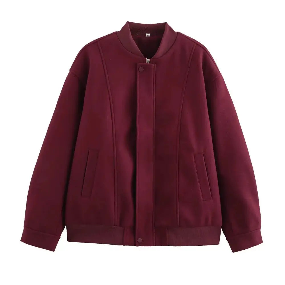 Jaqueta bomber feminina vermelha, com gola e punhos canelados, fechamento frontal por zíper oculto e bolsos embutidos, exibida em fundo branco.