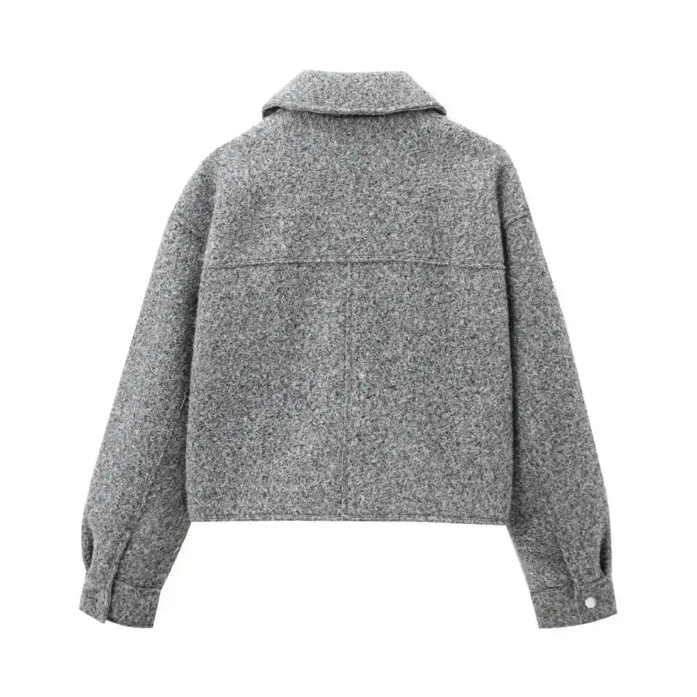 Vista traseira da jaqueta feminina cinza com textura de lã, detalhe de costuras nas costas e punhos, exibida sobre fundo branco.